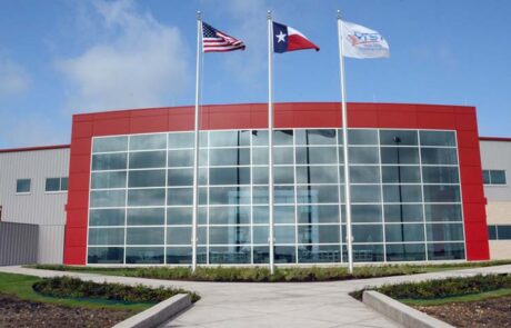 Glass-fronted building with American and Texas flags